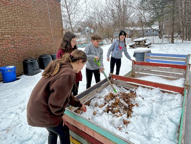 ABOVE: Students work on an outside bed; LEFT: Amelia Walsh, an 11th grader, lines the waste collection buckets with newspaper after emptying the food scraps into the composters at the Hopkinton Middle High School; RIGHT: Merrick Chapin, an 11th grader, shovels dried leaves to add to the composters at the Hopkinton High Middle School.