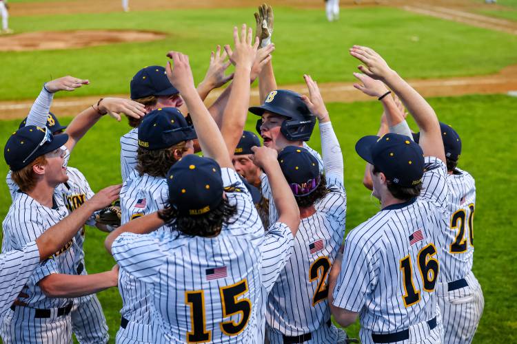 Bow baseball celebrates around Colby Smith after Smith scored a run in the Falcons’ 10-2 win over John Stark in the Division II semifinals on June 5. Bow upset John Stark, the No. 1 seed, and went on to win the championship.