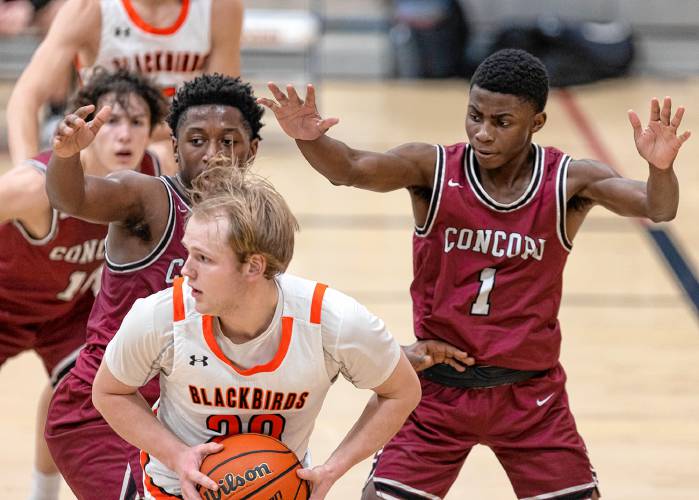 Concord’s Japhet Nduwayo (1) and Elia Bahuma (left) guard Keene senior Sam Timmer (20) during a game on Jan. 3 at Purbeck Gym in Keene. Nduwayo scored 32 points to lead the Concord boys’ basketball team to a 57-48 victory. Both players are back to lead the Crimson Tide’s back court this season.