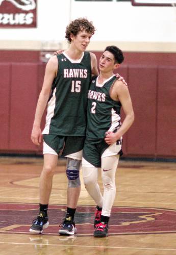 Hopkinton players Gavin Davies (left) and Noah Aframe hug at the end of their Division III semifinal game against Gilford on Feb. 22. The Hawks made a run to the final four in Matt Miller’s first season as head coach.