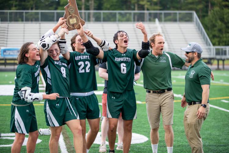 From left, Hopkinton boys’ lacrosse captains Patrick Buss (14), Steven Reddy (8), Lincoln Wilson (22) and John Despres (6), head coach Deacon Blue and assistant coach Kyle Devitte celebrate with the championship plaque after the No. 5 Hawks defeated No. 2 Campbell, 7-4, to win the NHIAA Division III title on June 11, 2023, at Exeter High School’s Bill Ball Stadium.