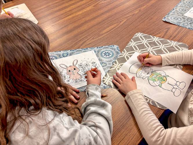 Children participate in coloring activities at the Bow Youth Center.