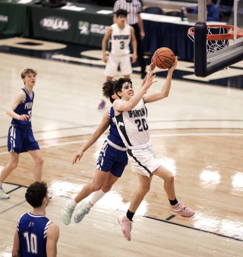 Pembroke guard Joe Fitzgerald (center) goes up for a layup against Pelham during the first half. Pelham defeated the Spartans, 57-54, in last year’s Division II championship on March 12. Fitzgerald is back to lead the Spartans in 2023-24.