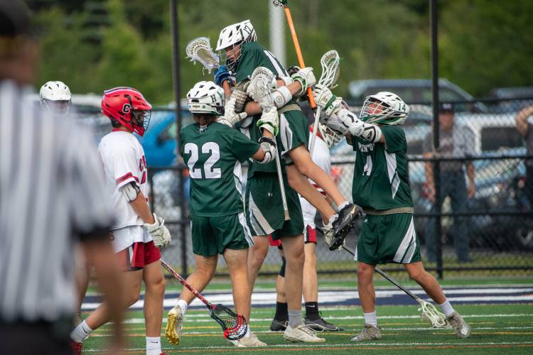 Hopkinton players lift up Merrick Chapin (17) in celebration after Chapin scored with 2:38 left in the NHIAA Division III boys’ lacrosse championship on June 11, 2023, at Exeter High School’s Bill Ball Stadium. Chapin's goal gave the No. 5 Hawks the final tally in a 7-4 victory over No. 2 Campbell. 
