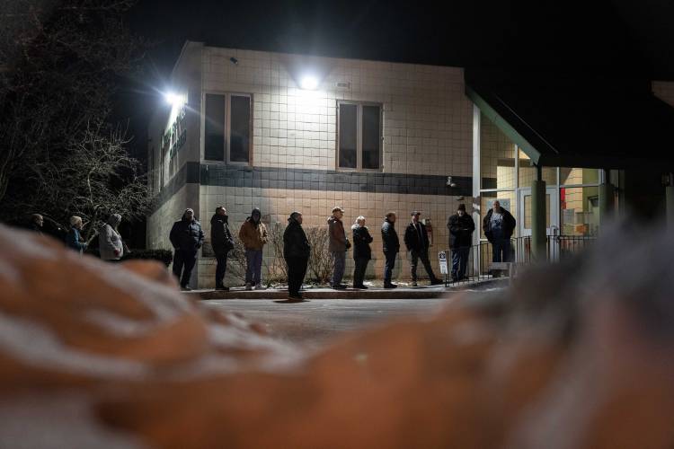 Voters line up for the polls to open to cast their ballots in the New Hampshire Republican presidential primary in Manchester, N.H., Tuesday, Jan. 23, 2024. (AP Photo/David Goldman)