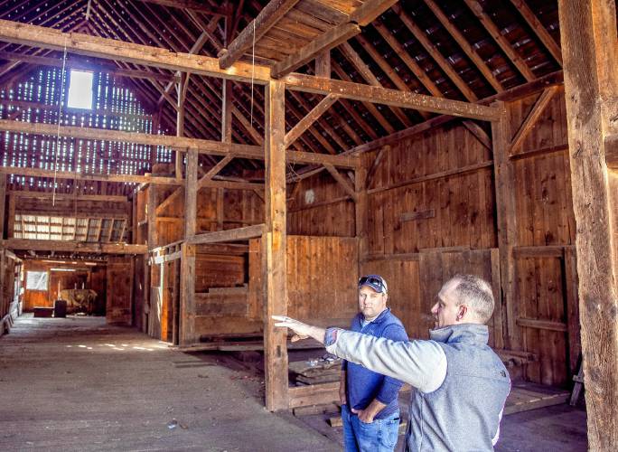 Cedar Mill Group project managers Nick Colarusso (right) and Nick Domenici on the first floor of the red barn the company purchased on Tuesday, April 9.