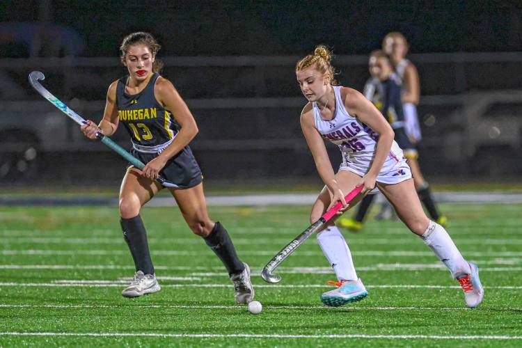 John Stark’s Lauryn Guevin keeps the ball away from Souhegan’s Sophia Merenda during the teams’ Division II field hockey semifinal in Exeter on Oct. 26. Guevin scored twice in the win, eventually leading the Generals to their second straight state crown.