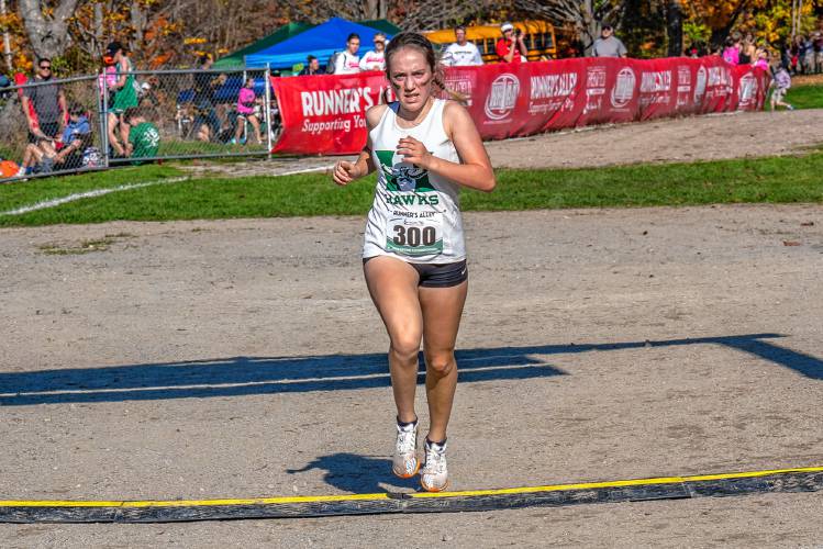 Hopkinton’s Maddie Lane crosses the finish line to become the NHIAA Division III girls’ state champion at Derryfield Park in Manchester on Oct. 28.
