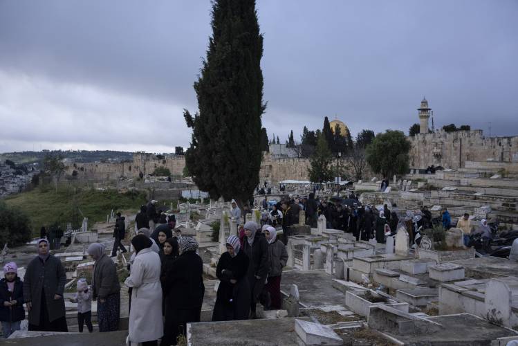 Palestinians visit the graves of their relatives after Eid al-Fitr prayers, during the celebrations at the end of the Muslim holy fasting month of Ramadan, at a cemetery just outside Jerusalem’s Old City walls, on April 10.