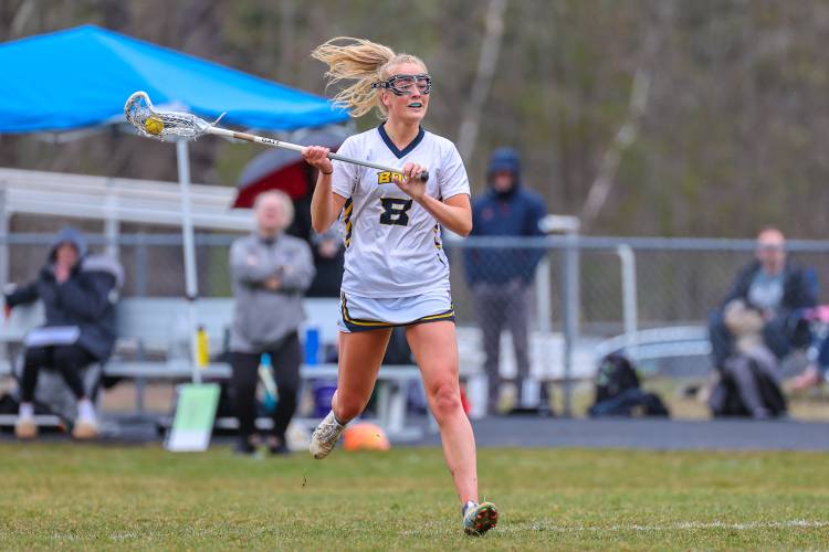 Bow’s Olivia Selleck looks to pass to a teammate during a home game on Wednesday. Bow defeated Bishop Brady, 19-2, to give Falcons’ girls’ lacrosse head coach Chris Raabe her 300th career victory.