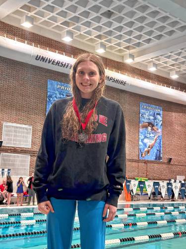 Concord's Lily Peterson poses with her silver medal after finishing second in the 100-yard breaststroke at the NHIAA Division I championship at the University of New Hampshire's Swasey Pool on Saturday.