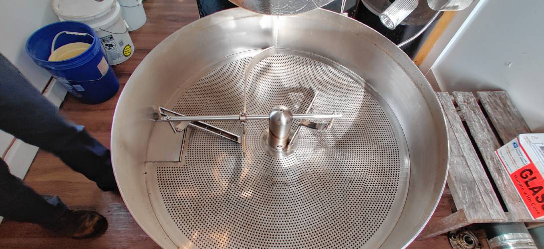 After roasting, the coffee beans are deposited into this cooling tray, which agitates the beans to speed up the cooling process.