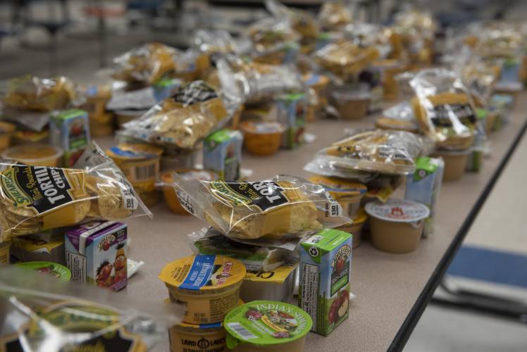Some of the items for meals in the twice-weekly distributions program are lined up in the JFK Middle School cafeteria on Thursday, April 30, 2020. Friday, May 1, is School Lunch Hero Day.