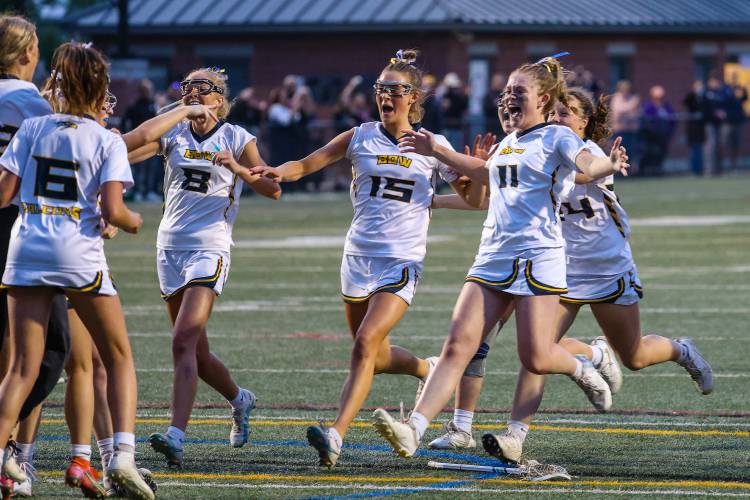 Bow’s Olivia Selleck (8), Alex Larrabee (15) and Kate McGovern (11) rush to join their teammate in celebrating the Falcons’ NHIAA Division III girls’ lacrosse title win last June over St. Thomas, 20-6, in Laconia, the program’s first state championship since 2009.