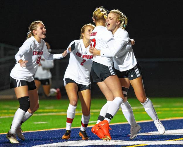 Coe-Brown celebrates Abbey Franke’s (12) goal in the fifth minute of the Division II girls’ soccer championship game against Hollis-Brookline on Nov. 5. Coe-Brown led all area’s girls’ soccer programs with five All-State selections.