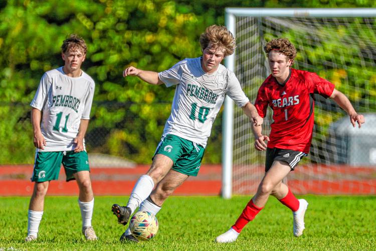 Pembroke midfielder Colby Pepka controls the ball for the Spartans as Coe-Brown’s Bruce LaPierre comes in from behind during a match on Oct. 3. Pepka was named to the Division II All-State First Team.