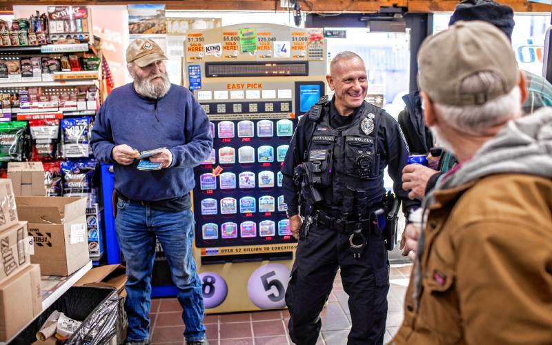 Pittsfield police officer Don Bolduc greets the customers at the Bell Brothers convenience store in downtown on Thursday, February 8, 2024. 