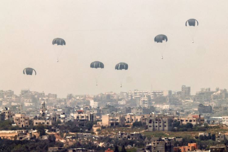 This picture taken from Israel’s southern border with the Gaza Strip shows an airdrop of humanitarian aid over the besieged Palestinian territory on Thursday, March 28.
