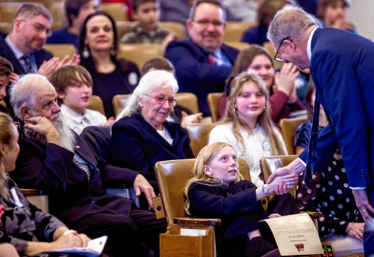 New Hampshire Kid Governor Jade Adams shakes Secretary of State David Scanlan hands after he presented her with the document making it official at Representative Hall on Tuesday, January 28, 2025. Adams is a fifth grade student at Wells Memorial School in Harrisville.