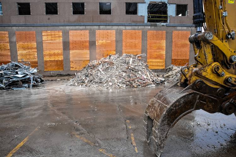 The demolition of the former Department of Justice building on North State Street is proceeding with piles of materials gathered outside the structure on Capitol Street side on Thursday, March 7, 2024.