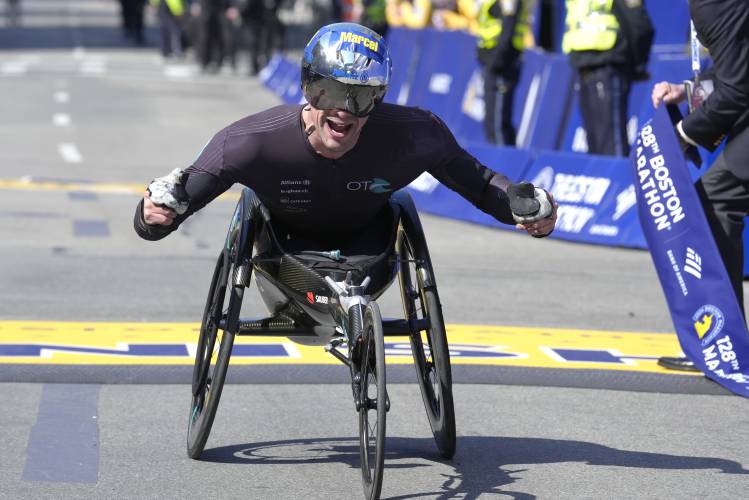 Marcel Hug, of Switzerland, celebrates as he wins the men's wheelchair division of the Boston Marathon, Monday, April 15, 2024, in Boston. (AP Photo/Steven Senne)