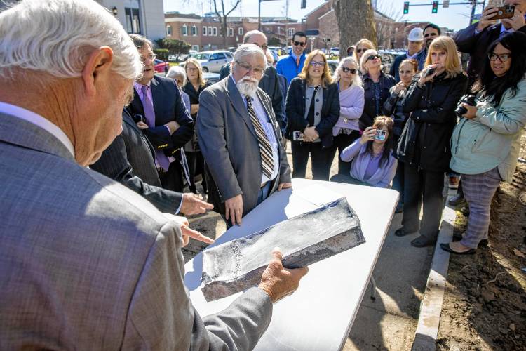 Senator Jeb Bradley inspects the time capsule as they figure out how to open it at the former DOJ and Mechanics Bank building on North State Street on Tuesday, April 9, 2024.